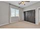 Bedroom featuring carpet, ceiling fan, and closet with black doors at 3047 Whispering Crest Dr, Henderson, NV 89052