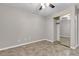 Bedroom features tile floors, a ceiling fan, and a mirrored closet for storage, offering a neutral, comfortable space at 3047 Whispering Crest Dr, Henderson, NV 89052