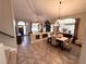 Elegant dining space with tile flooring, modern lighting, and an open flow to the living area at 3047 Whispering Crest Dr, Henderson, NV 89052