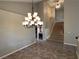 Dining area with modern chandelier lighting and an open stairway at 3047 Whispering Crest Dr, Henderson, NV 89052