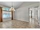Dining room showcasing vaulted ceilings, decorative chandelier, and a neutral color palette at 3047 Whispering Crest Dr, Henderson, NV 89052