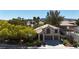 Charming two-story home with a well-manicured lawn, three-car garage and mature trees in a desirable neighborhood at 3047 Whispering Crest Dr, Henderson, NV 89052