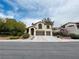 Charming two-story home with a well-manicured lawn and a three-car garage, located in a friendly neighborhood at 3047 Whispering Crest Dr, Henderson, NV 89052