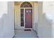 Charming front porch with a rustic front door, textured exterior walls, and desert accents at 3047 Whispering Crest Dr, Henderson, NV 89052