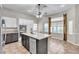 Modern kitchen with white cabinetry, stainless steel appliances, and center island with a sink at 3047 Whispering Crest Dr, Henderson, NV 89052