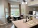 Bright kitchen area featuring a sink, tile floors, large windows and a cozy breakfast nook with backyard views at 3047 Whispering Crest Dr, Henderson, NV 89052