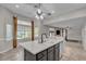 Inviting kitchen area boasting a central island with a sink, along with ample natural light at 3047 Whispering Crest Dr, Henderson, NV 89052