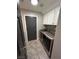 Efficient laundry room with white cabinets and stainless steel washer and dryer at 3047 Whispering Crest Dr, Henderson, NV 89052