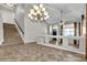 Inviting living room featuring a staircase, a large chandelier, and a vaulted ceiling at 3047 Whispering Crest Dr, Henderson, NV 89052