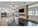 Bright open living room with fireplace, tile floors and natural lighting, seamlessly connecting living spaces at 3047 Whispering Crest Dr, Henderson, NV 89052