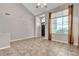 Open living room with large windows, vaulted ceilings, tile flooring, and neutral wall color at 3047 Whispering Crest Dr, Henderson, NV 89052