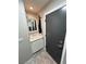 Practical mud room area with a sink, mirror, and storage for coats and accessories at 3047 Whispering Crest Dr, Henderson, NV 89052
