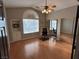 Spacious home office with wood floors, a mirrored closet, and built-in shelving near a large window at 3047 Whispering Crest Dr, Henderson, NV 89052