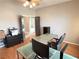 Bright office features a modern glass-topped desk with hardwood floors and neutral walls at 3047 Whispering Crest Dr, Henderson, NV 89052