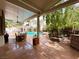 Spacious covered patio area with a view of the pool and backyard at 3047 Whispering Crest Dr, Henderson, NV 89052