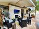 Spacious covered patio featuring comfortable seating, an outdoor fireplace, and backyard access at 3047 Whispering Crest Dr, Henderson, NV 89052