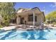 Inviting pool area features a covered patio, creating a perfect backyard oasis for relaxing and entertaining at 3047 Whispering Crest Dr, Henderson, NV 89052