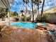 Backyard featuring a swimming pool, palm trees, and a jacuzzi at 3047 Whispering Crest Dr, Henderson, NV 89052