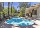 Sparkling swimming pool with mature landscaping and a covered patio area for relaxing and entertaining guests at 3047 Whispering Crest Dr, Henderson, NV 89052