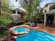 Backyard area featuring a pool and spa tub, patio and garden with mature trees providing shade at 3047 Whispering Crest Dr, Henderson, NV 89052