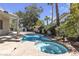 Backyard oasis with a swimming pool, hot tub, mature landscaping, and ample patio space at 3047 Whispering Crest Dr, Henderson, NV 89052