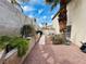Side yard with stone path, gravel, and mature landscaping at 3047 Whispering Crest Dr, Henderson, NV 89052