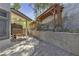 Side yard featuring shaded walkway and privacy wall with lighting and custom wood accents at 3047 Whispering Crest Dr, Henderson, NV 89052