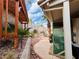 Landscaped side yard with mature trees and manicured stone at 3047 Whispering Crest Dr, Henderson, NV 89052
