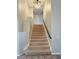 Carpeted stairway leading to the upper level, enhanced by a modern ceiling fan at 3047 Whispering Crest Dr, Henderson, NV 89052