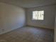 Cozy bedroom with neutral walls, decorative window bars, and tile flooring, ready for personalization at 3572 Tempe St, Las Vegas, NV 89103