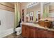 Well-appointed bathroom with wooden vanity, sink, and decorative fixtures at 3975 N Hualapai Way # 285, Las Vegas, NV 89129