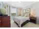 Comfortable bedroom features a queen bed, decorative floral accents, and a bright window view at 3975 N Hualapai Way # 285, Las Vegas, NV 89129