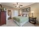 Spacious bedroom with queen bed, ceiling fan, and ensuite bathroom at 3975 N Hualapai Way # 285, Las Vegas, NV 89129