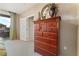 Bedroom boasts a wooden dresser with a view of the outdoor balcony at 3975 N Hualapai Way # 285, Las Vegas, NV 89129