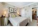 Charming bedroom with queen bed, side tables, decorative accents, and a doorway to the bathroom at 3975 N Hualapai Way # 285, Las Vegas, NV 89129