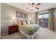 Bedroom with large windows, queen bed, ceiling fan, and sliding door access to a patio at 3975 N Hualapai Way # 285, Las Vegas, NV 89129