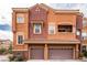 Inviting multi-Gathering townhome showcases a tile roof and brown garage doors, providing convenience and curb appeal at 3975 N Hualapai Way # 285, Las Vegas, NV 89129