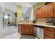 Well-appointed kitchen with stainless steel appliances, tile backsplash, and views to living room offering modern functionality at 3975 N Hualapai Way # 285, Las Vegas, NV 89129
