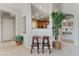 Hallway featuring barstool seating, offering seamless transition to the kitchen and open views into the bedroom at 3975 N Hualapai Way # 285, Las Vegas, NV 89129