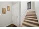 Welcoming stairwell with carpeted steps and white railing, providing a seamless transition between floors at 3975 N Hualapai Way # 285, Las Vegas, NV 89129