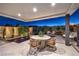 Outdoor dining by the pool and scenic mountain views provides an ideal spot for relaxation and entertainment at 4077 Heron Fairway Dr, Las Vegas, NV 89141