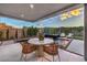 Inviting outdoor dining area by the pool with scenic views offers a perfect blend of luxury and serene relaxation at 4077 Heron Fairway Dr, Las Vegas, NV 89141
