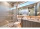 Modern bathroom with a glass shower, textured tile wall, and sleek vanity with a vessel sink at 4077 Heron Fairway Dr, Las Vegas, NV 89141