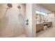 Modern bathroom featuring tiled walls, double shower heads, and a separate vanity area at 4077 Heron Fairway Dr, Las Vegas, NV 89141