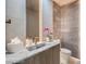 Modern powder room featuring elegant marble finishes, a stylish sink, and chic decor creating a sophisticated space at 4077 Heron Fairway Dr, Las Vegas, NV 89141