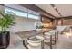 Dining area featuring a long wooden table, modern chairs, and bright window, perfect for gatherings and everyday meals at 4077 Heron Fairway Dr, Las Vegas, NV 89141