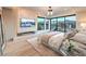 Bright main bedroom featuring a stone accent wall, fireplace, and scenic outdoor views at 4077 Heron Fairway Dr, Las Vegas, NV 89141