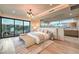 Inviting main bedroom with a balcony, glass wall and an adjacent bathroom at 4077 Heron Fairway Dr, Las Vegas, NV 89141