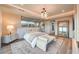 Serene main bedroom with a large mirror, soft lighting, and a cozy sitting area at 4077 Heron Fairway Dr, Las Vegas, NV 89141