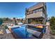 Backyard oasis features a modern pool, lounge seating, and an outdoor dining area for relaxation and entertainment at 4077 Heron Fairway Dr, Las Vegas, NV 89141